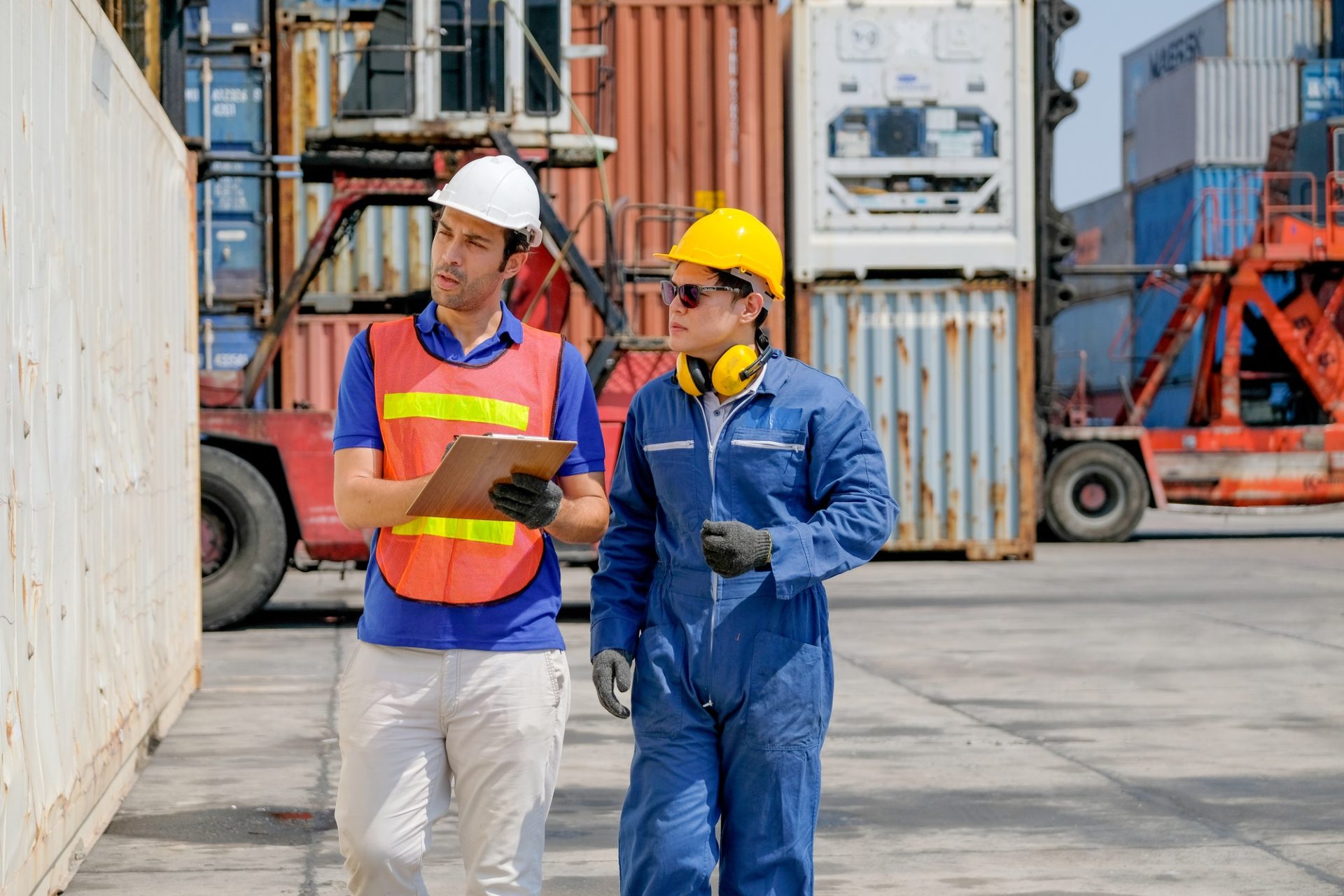 Technician and engineer work together for checking quality and product in cargo container